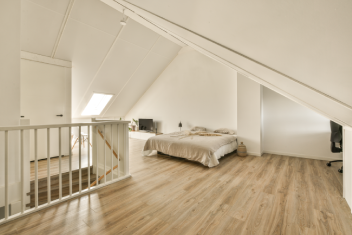 Bedroom Interior with Bed and Sloped Ceiling