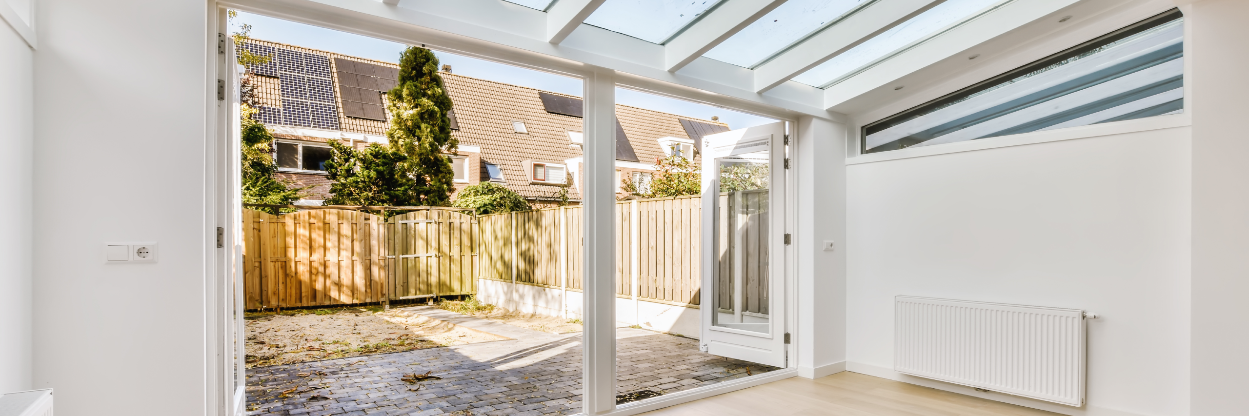 Bright Sunroom with View of Fenced Yard