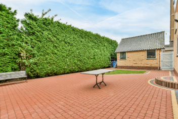 Exterior of Suburban Home with Green Hedge